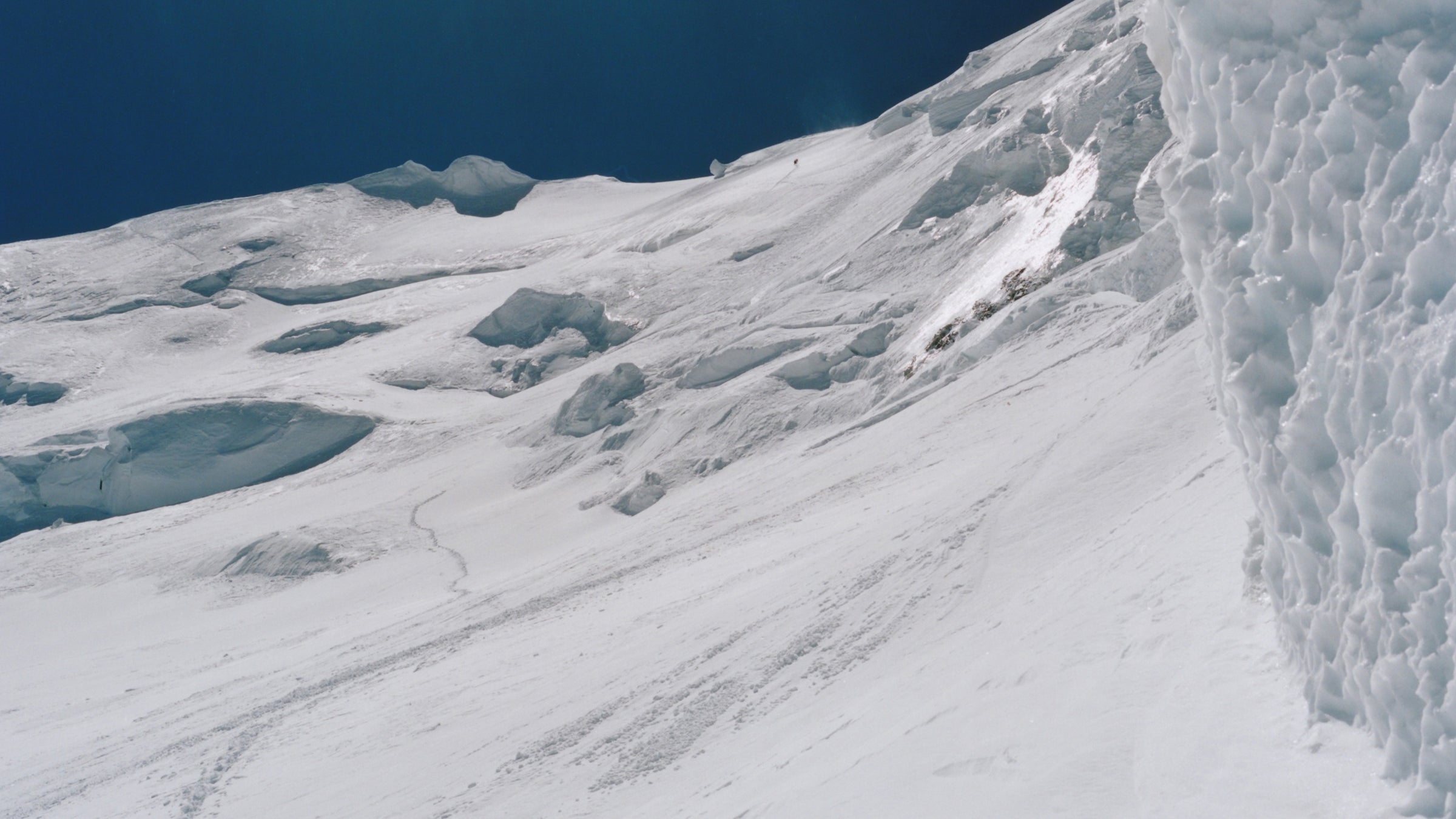Three climbers high up a mountain