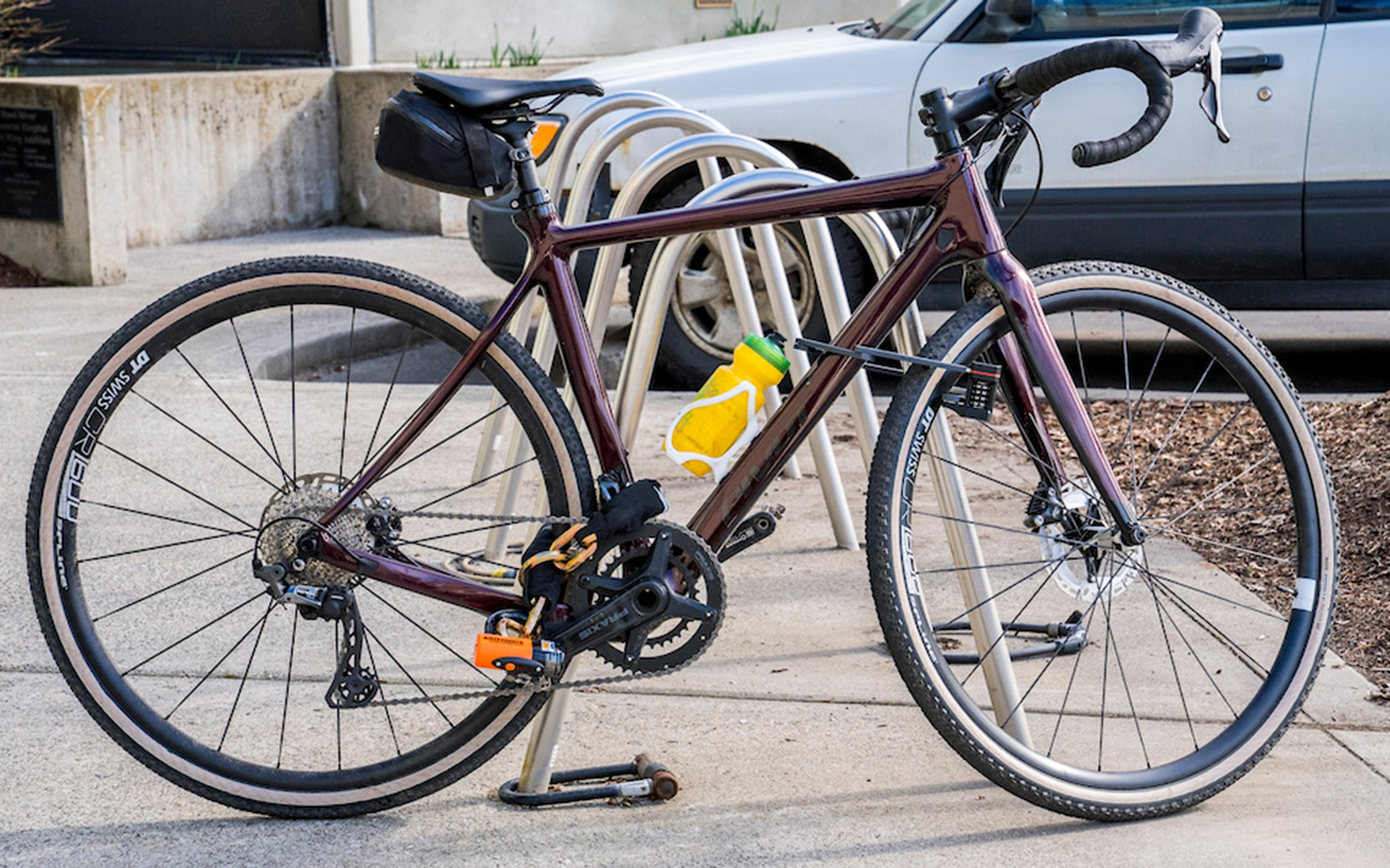 a road bike chained to a bike rack with one of the best bike locks