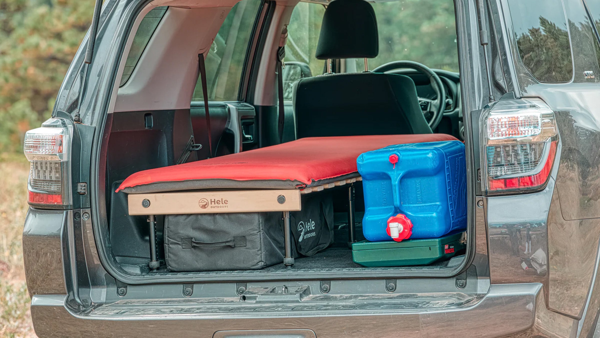 Closeup of Hele Box Solo Car Camping Platform in the back of an SUV with car camping gear