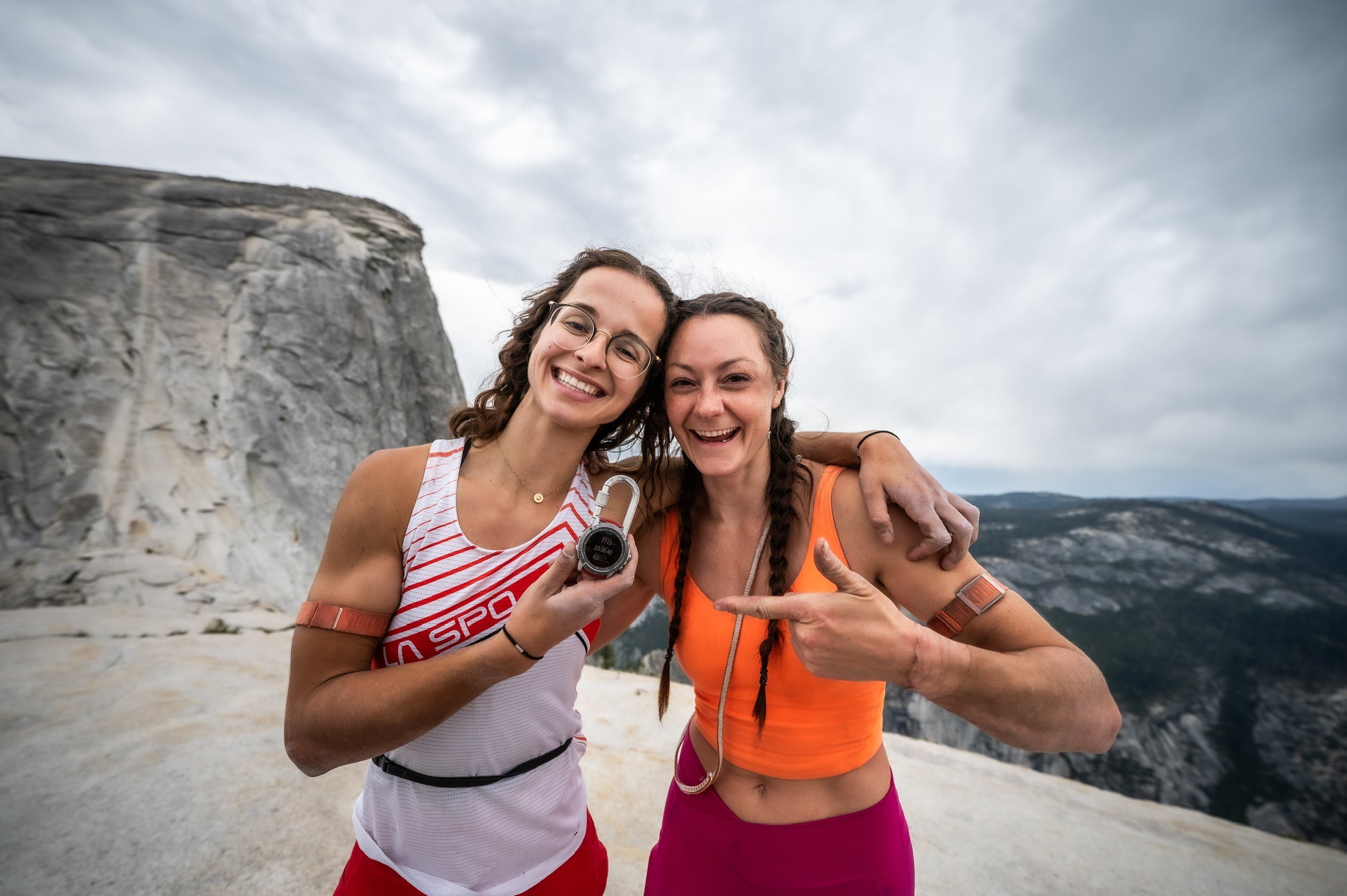 two women standing on top of half dome after completing the yosemite triple crown