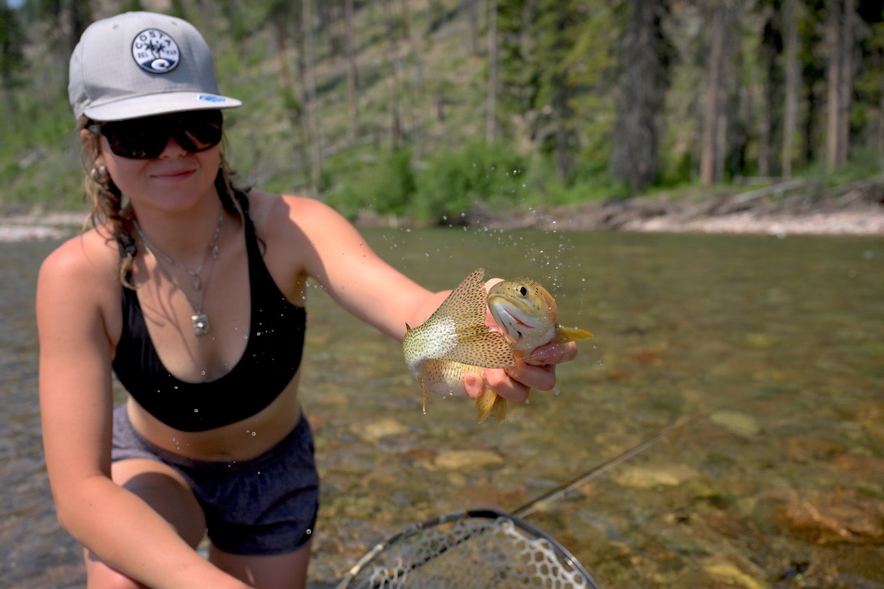woman holding a golden fish