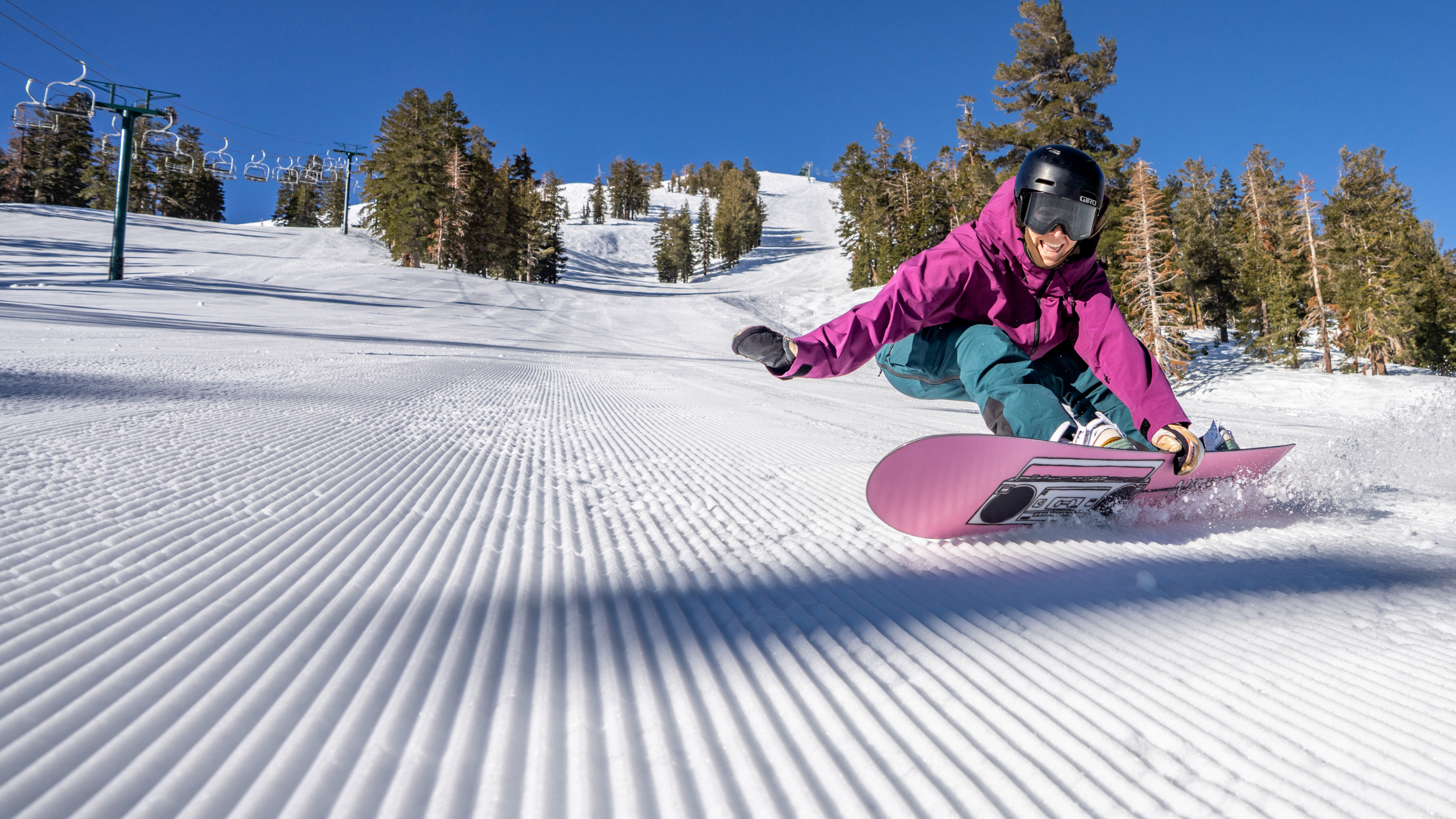 woman riding snowboard on corduroy