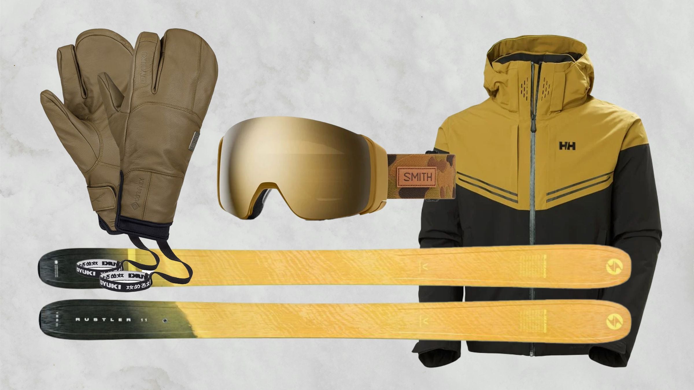 Yellow, black, and gold skis, ski gloves, goggles and ski jacket on white snowy background