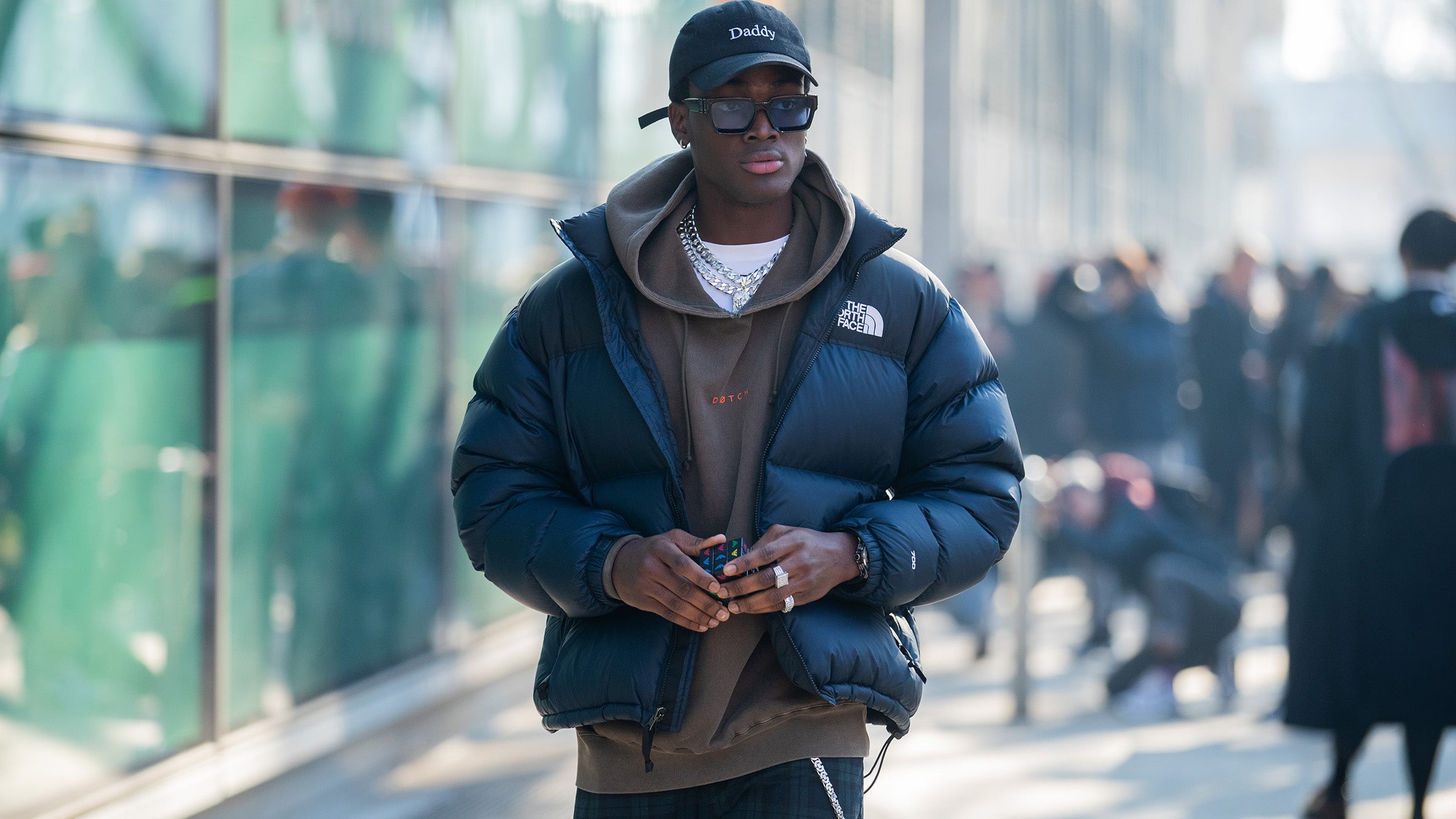 Man wearing The North Face Nuptse puffy jacket in urban setting
