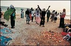 "In this sad life": Pentecostal worshipers dance on the beach south of Luanda after a funeral.