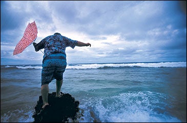 Start bailing: Former Prime Minister Bikenibeu Paeniu braves the incoming swells on Funafuti Atoll.