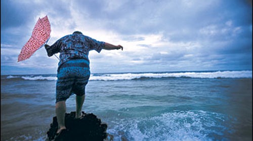 Start bailing: Former Prime Minister Bikenibeu Paeniu braves the incoming swells on Funafuti Atoll.