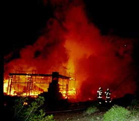 Scorched earth: One of 11 luxury homes burned in the past two years goes up in smoke, December 2000.