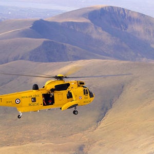 A Royal Air Force helicopter searches for missing climbers