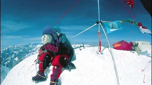 Say cheese: French mountaineer Thierry DeFrance checks his camera near the summit survey marker before descending.