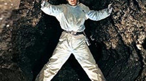 Ukrainian Speleological Association member Yevgeni Kislistim straddles a passage inside Ozernaja Cave, in Western Ukraine