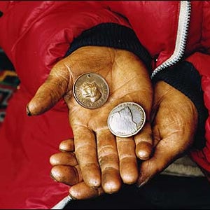 Pemba Thark&eacute; Sherpa holding the coveted Tiger Medal, bestowed on many of the greatest Sherpas, and a token from the 1965 Indian Everest Expedition
