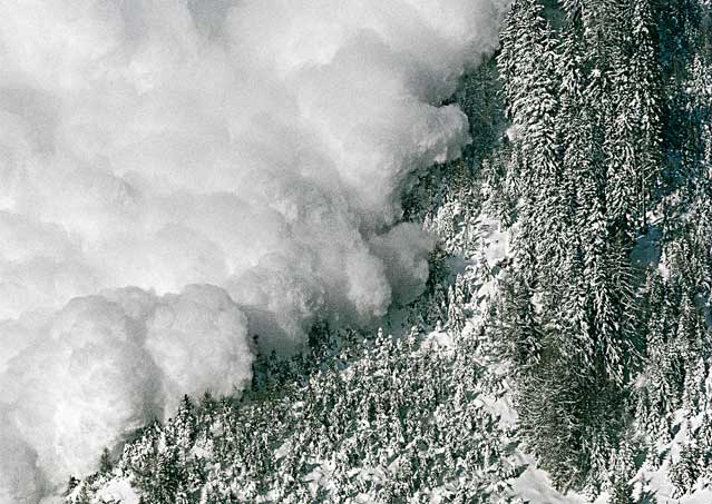 An avalanche rips down a mountainside.