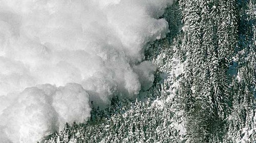An avalanche rips down a mountainside.