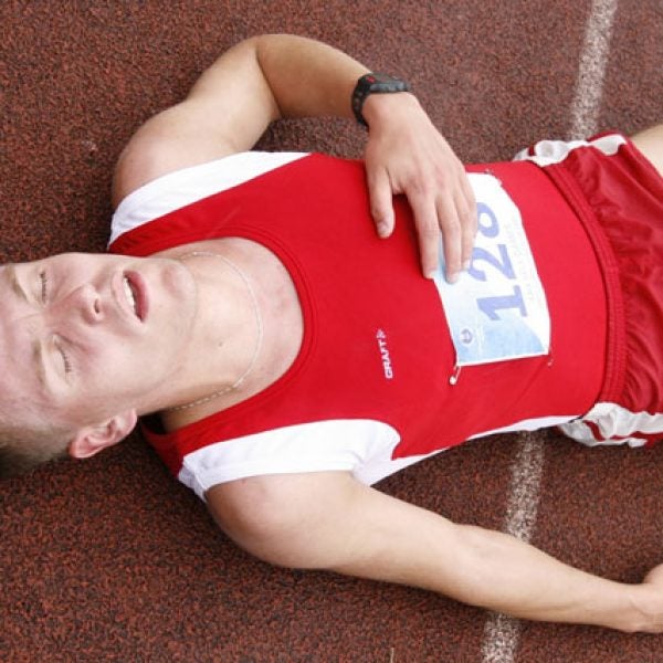 runner lying down running track