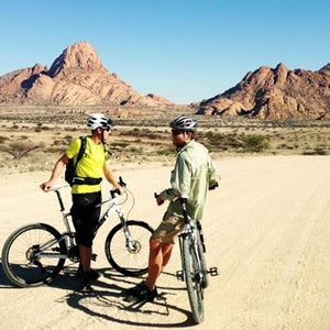 Riding beneath the Spitzkoppe, Namibia's most iconic peak.