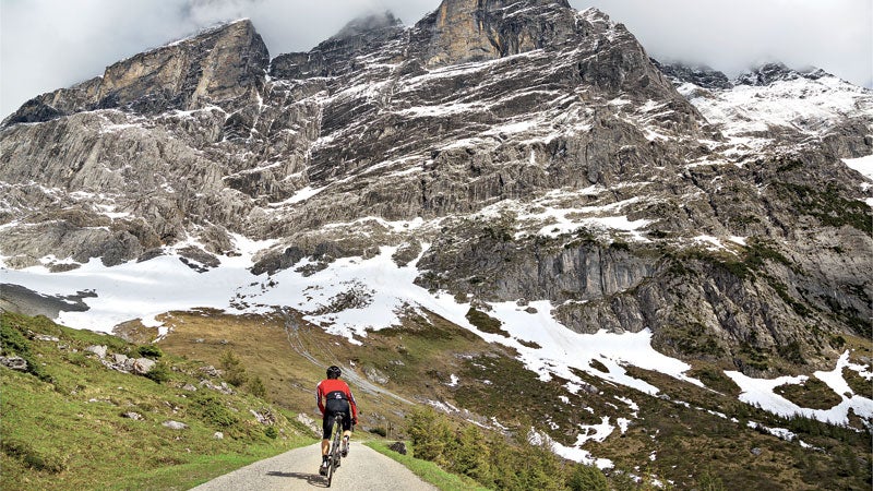 Berner Oberland Bernese Alps Europe Grindelwald Grosse Scheidegg Interlaken Magic Image Meiringen Spring Swiss Alps Switzerland The Magic autumn biking cloudy day cycling dramatic landscape figure in a landscape horizontal majestic male moody mountain one man one person rear view road biking training uphill weather