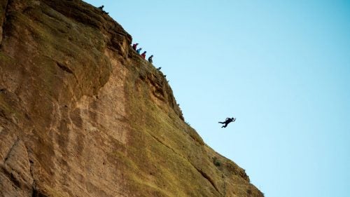 Joe Nesbitt performs a jump off a cliff near Apache Trail road, one hour northeast of Phoenix, Arizona. BASE is an acronym for: Building, Antenna, Span (bridges) and Earth (cliffs), the four main objects these parachutists tend to jump from.