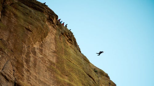 Joe Nesbitt performs a jump off a cliff near Apache Trail road, one hour northeast of Phoenix, Arizona. BASE is an acronym for: Building, Antenna, Span (bridges) and Earth (cliffs), the four main objects these parachutists tend to jump from.