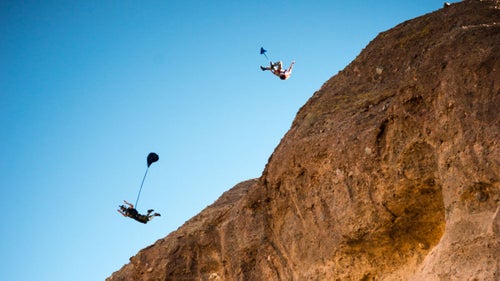 Jumpers Mathew Kenney and Jordan Kilgore perform a jump off Camelback Mountain in central Phoenix. Jordan is seen doing an advanced aerial named the “tweener.
