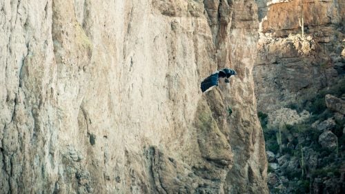 One of the most dangerous parts of jumping solid objects, such as cliffs, is the possibility that one’s parachute can open backward, causing the jumper to fly at the cliff. A 180, as it's called, can cause the parachute to snag and/or result in serious injury leaving the jumper dangling and helpless. In this photo James Yaru opened with a 180 but narrowly avoided the cliff as he managed to turn around with a couple feet to spare.