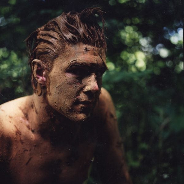 Learning by doing: a Tom Brown wanna-be prepares to stalk prey by muddying up his body to