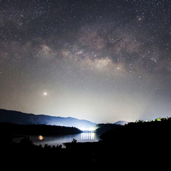 Panorama Milky Way rises over the dam in Thailand.