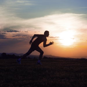 Silhouette man running on meadow