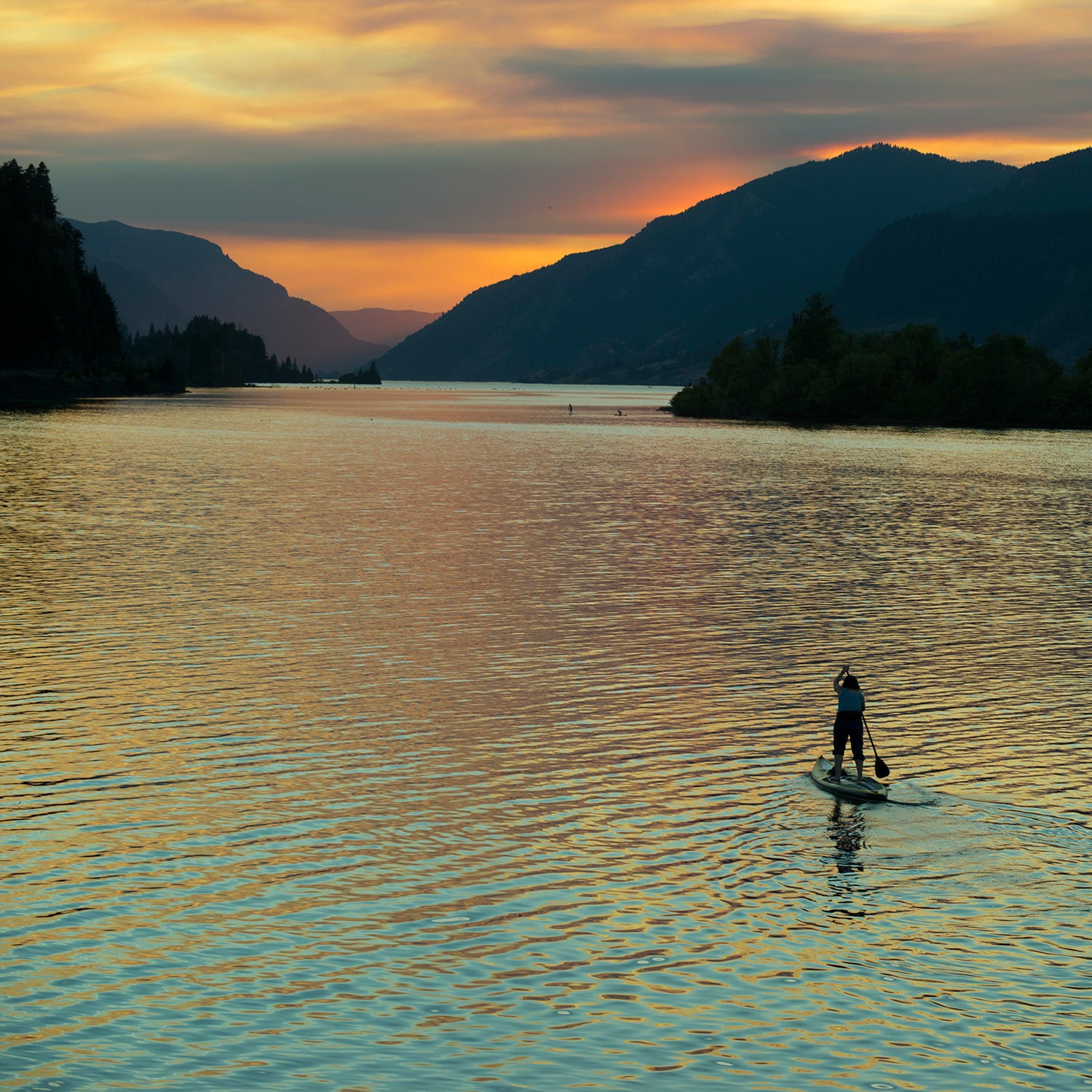 A brush fire lights up the sky over Hood River, Oregon, during an evening of SUP.