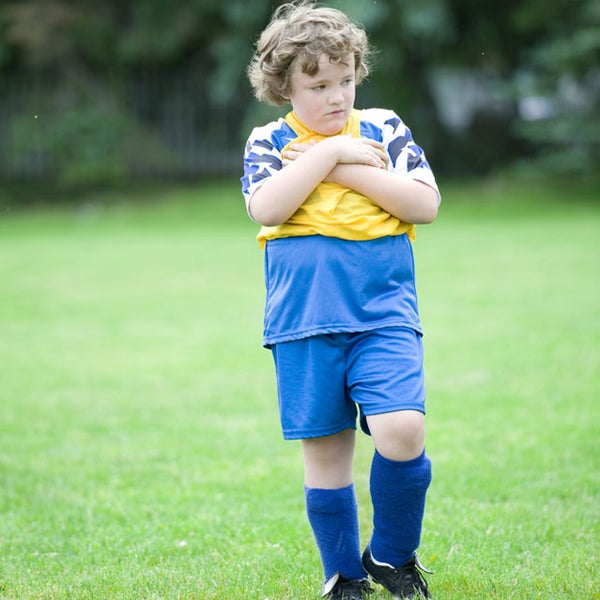 boy playing soccer uniform field pitch