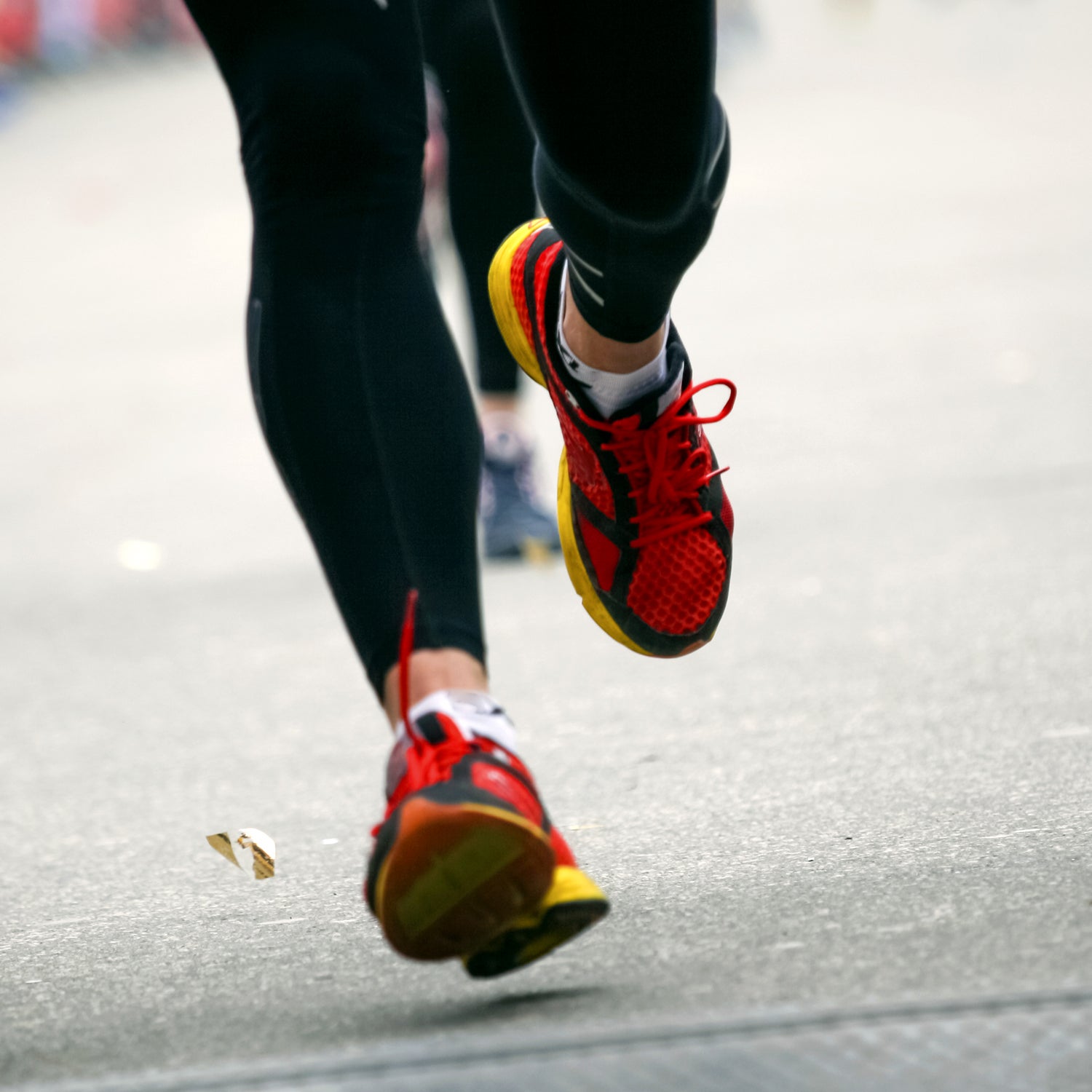 Marathon runner on finish line - legs closeup.
