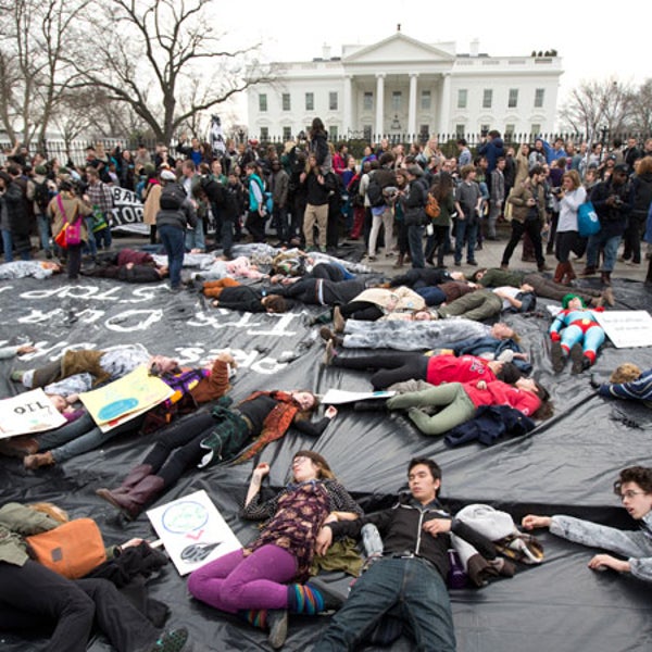Demonstrators lie down along Pennsylvania Avenue in front of the White House during a protest against the proposed Keystone XL oil pipeline, Sunday, March 2, 2014. The protestors say the pipeline would contribute to global warming.