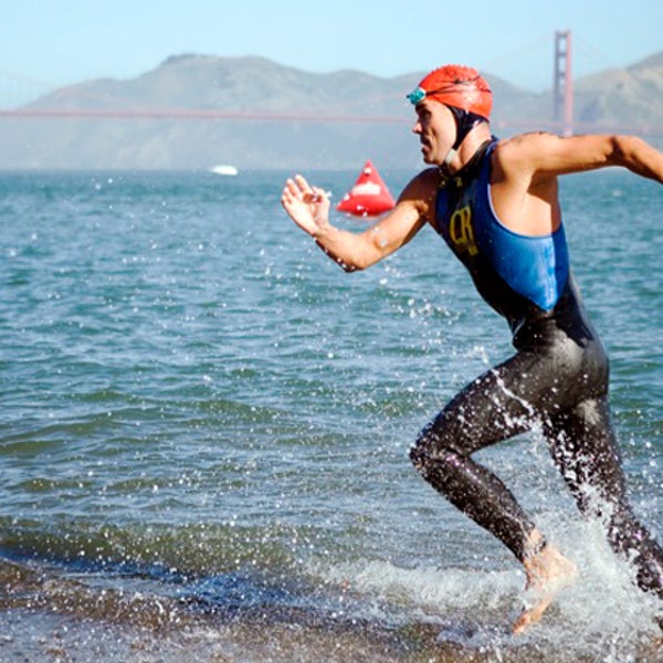A triathlete finishes the 1.5-mile swim from Alcatraz Island to San Francisco's shore.