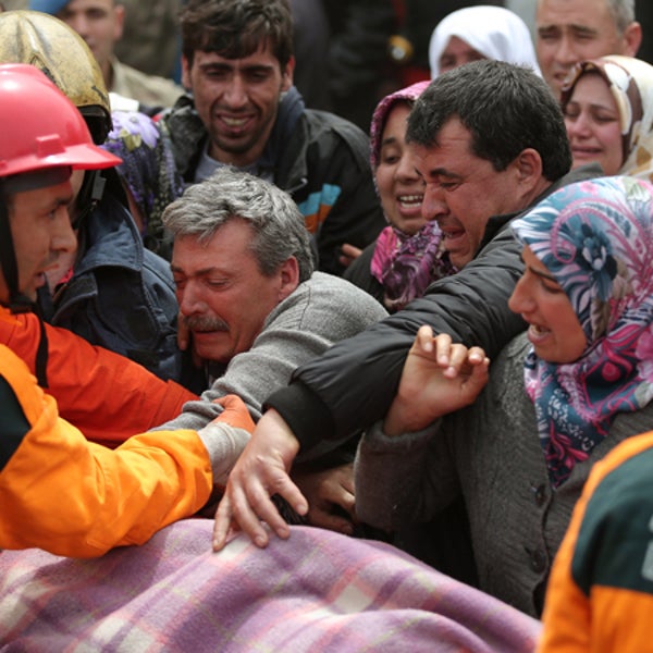 Rescue workers carry the body of a miner from the Soma mine early Wednesday. Many Soma residents still await news of people they know who may have been trapped in the mine.