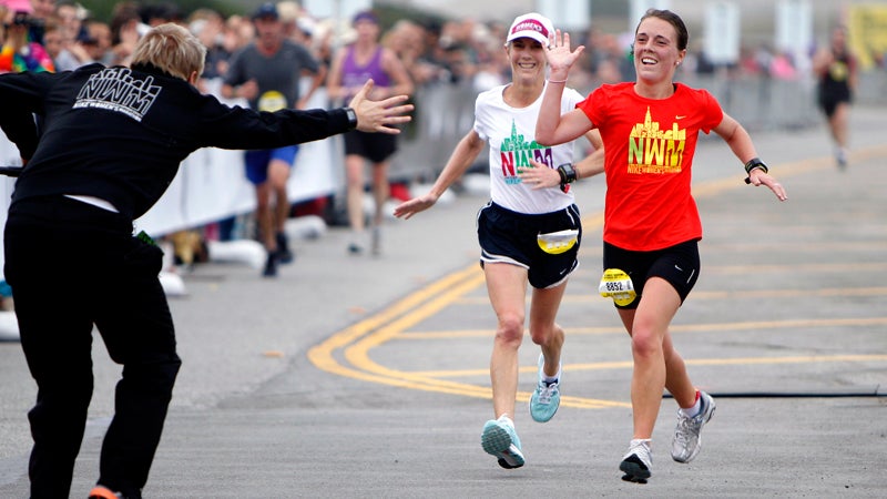 Joan Benoit Samuelson, left, American gold medalist in the 1984 Olympics, and her daughter, Abby, approach the finish line of the eighth annual Nike Women's Marathon in San Francisco.