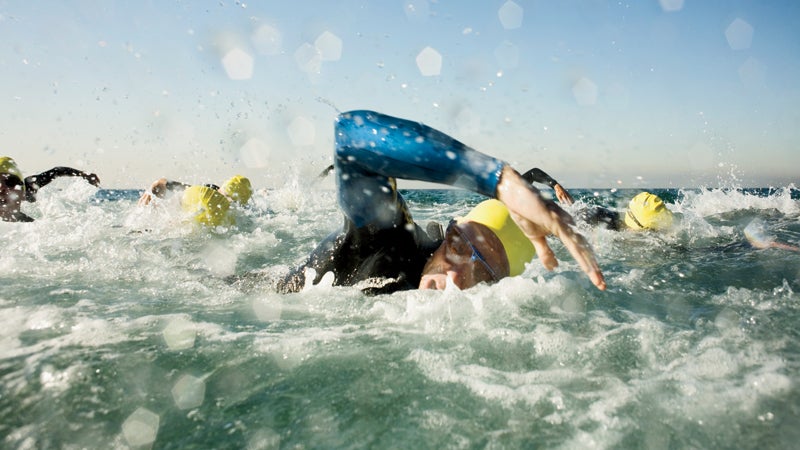 1 and Group 30s adult Adults Athlete Challenge Competition Endurance Fortitude Head and shoulders Intensity Males Marine scenes Men Mid-adult Mid-adult man Ocean Outdoors People Race Sports Sports event Swimmer Swimming Swimming competition Triathlete Triathlon Water Whites